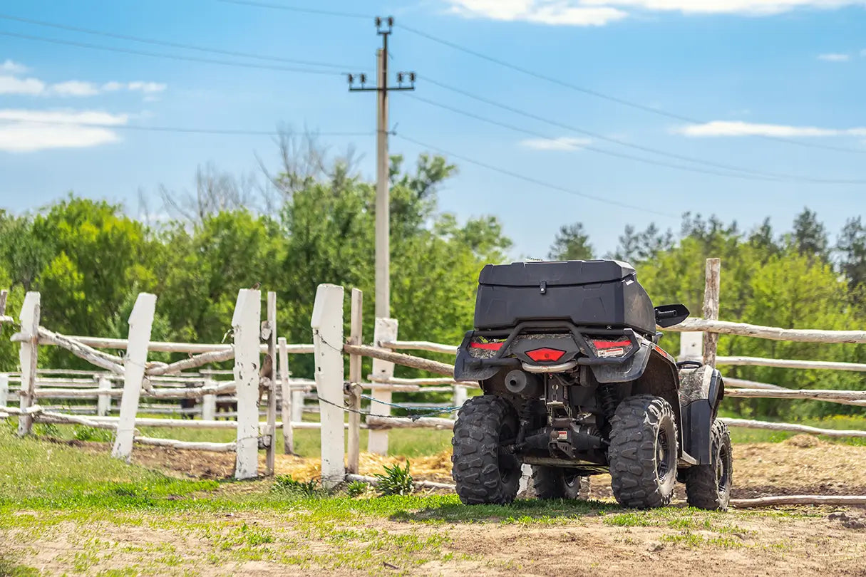 a four - wheeler parked in front of a wooden fence